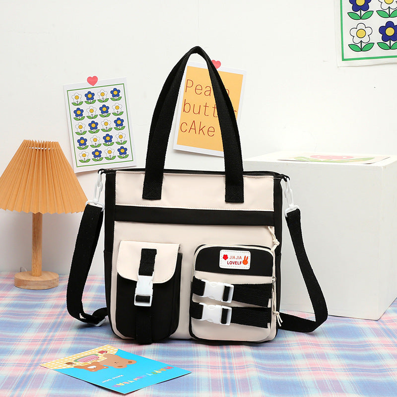 Japanese-style nylon art bag for elementary school students, featuring alphabet pattern and single shoulder strap design.