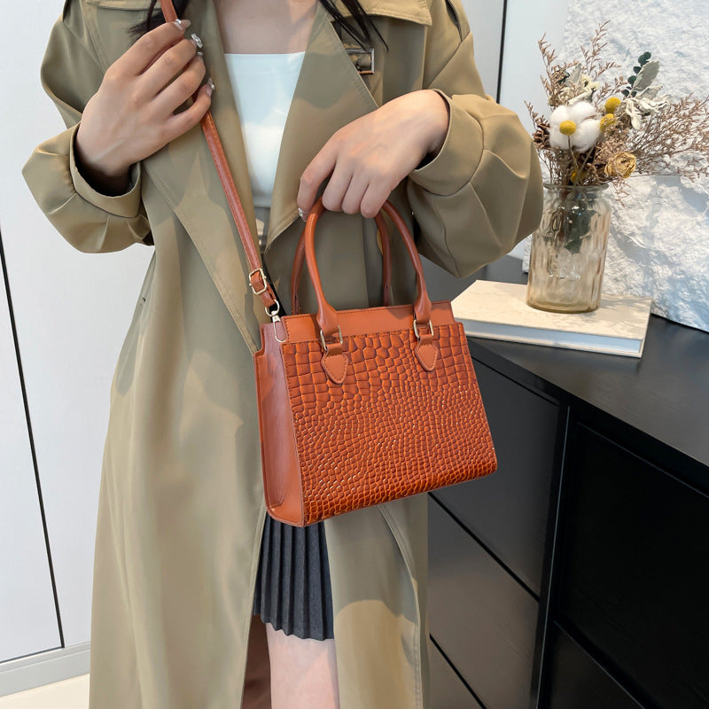 Large-capacity textured commuter tote with crocodile pattern in orange, featuring a three-dimensional pocket design.