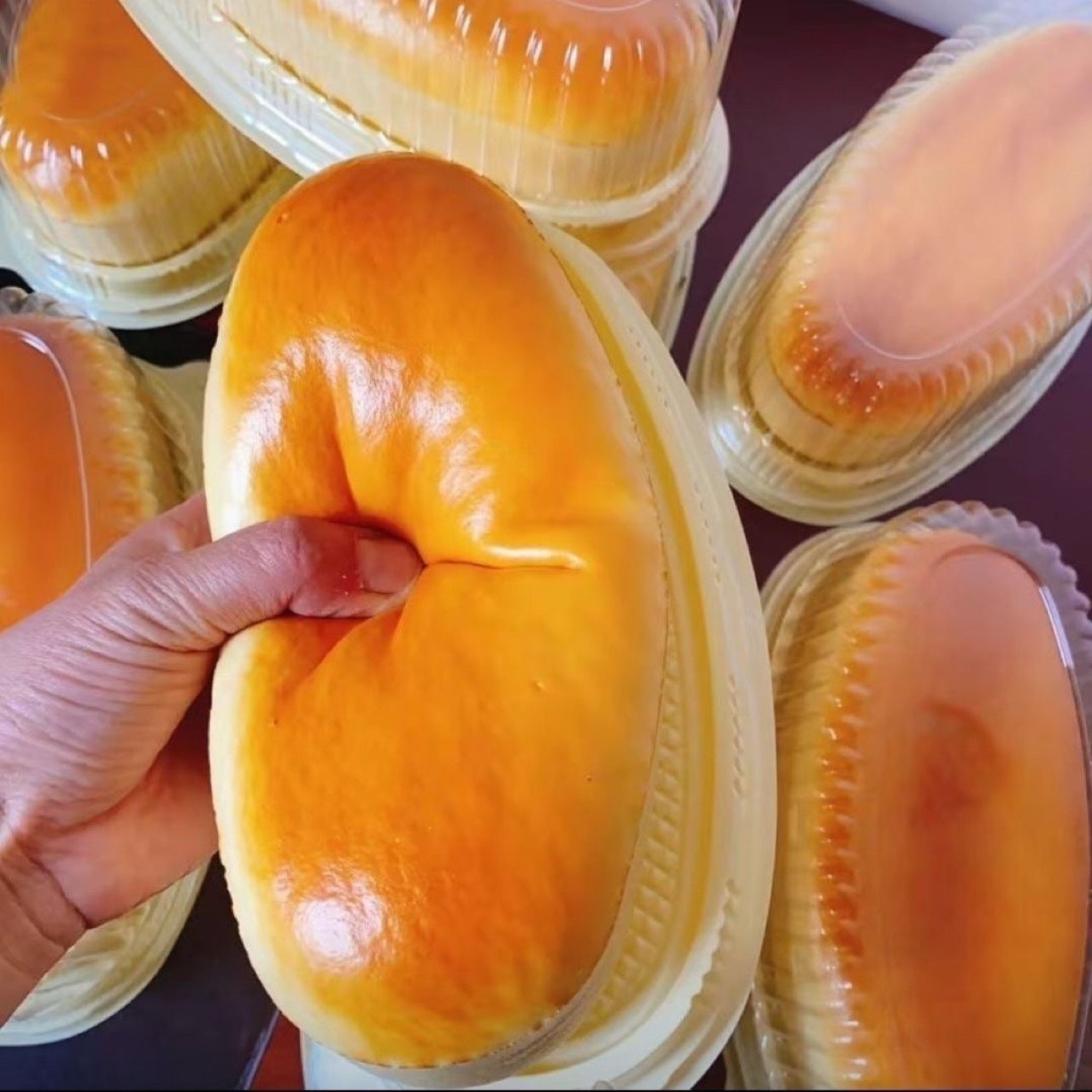 Slow rebound simulation food cheese cake musical toy, hand squeezing a yellow cake-shaped PU toy, modern decorative style.