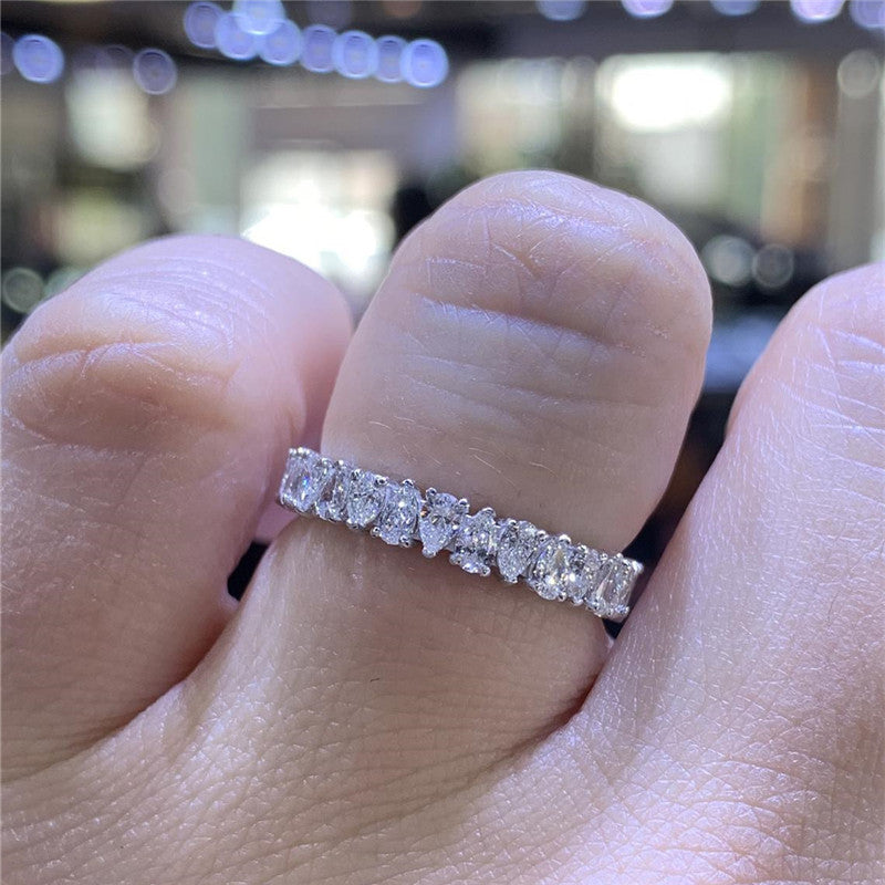 Unisex silver ring with inlaid waterdrop rhinestones, showcasing simple luxury style.