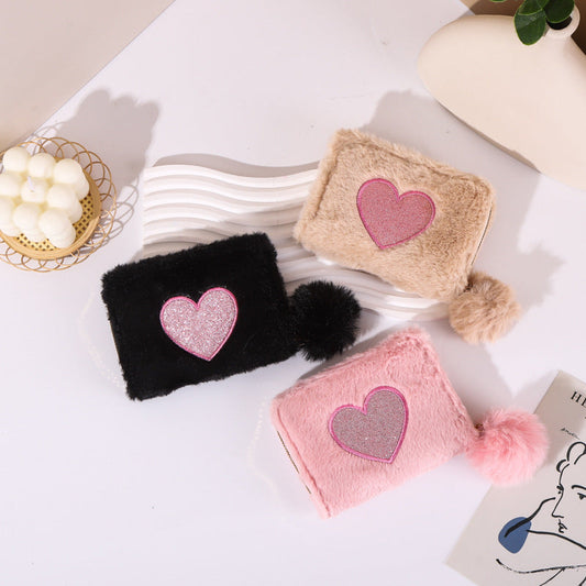 Plush coin purses with love embroidery and zipper in black, beige, and pink, featuring heart designs.
