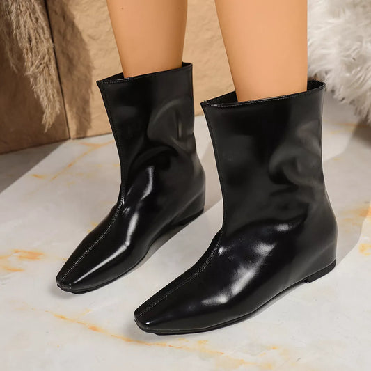 black point toe leather boots with mid heels and smooth finish