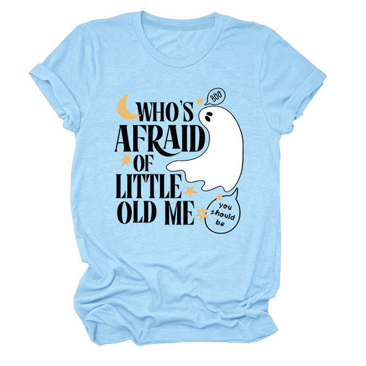 Light blue t-shirt with "Who's Afraid Of Little Old MeT" text and a playful ghost graphic, featuring a geometric pattern design.