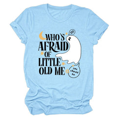 Light blue t-shirt with "Who's Afraid Of Little Old MeT" text and a playful ghost graphic, featuring a geometric pattern design.