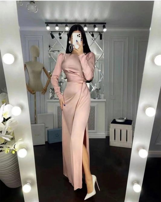 Elegant pink dress with waist-fitting design and irregular hem, displayed in a well-lit room.