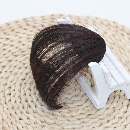 Realistic mini bangs wig piece made of high temperature wire displayed on a chair.