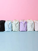 Large Texture Oxford Cloth travel bags in pastel colors with zipper and handle against pink background