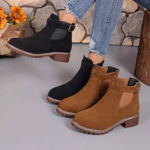 Round toe block heel boots in black and brown PU leather with mid-height heel and buckle detail