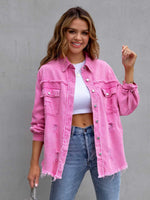 Pink distressed drop shoulder denim jacket with fringe detailing worn over white crop top and blue jeans