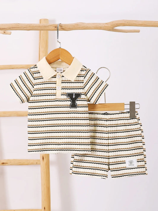 Children's striped short sleeve polo and pants set in beige and black with "Y" logo patch