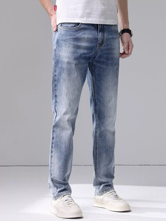 Men's washed slim fit jeans with cat's whisker detailing and slight stretch in light blue denim