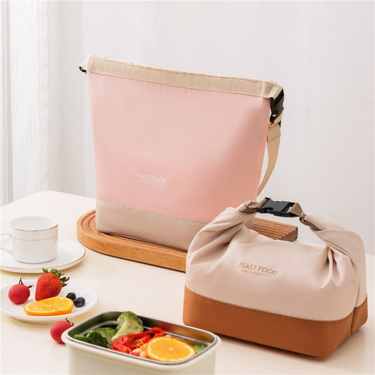 Functional crossbody lunch bags in pink and cream-white on a table.