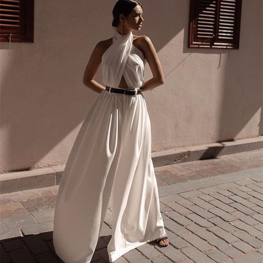 White polyester women's sleeveless halter backless jumpsuit with wide-leg pants.