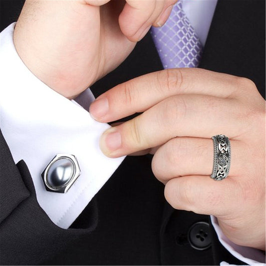 14k plated white diamond ring with hollow flower pattern worn with a suit.