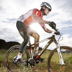 Cyclist wearing extended leg protection nylon leggings for optimal support.