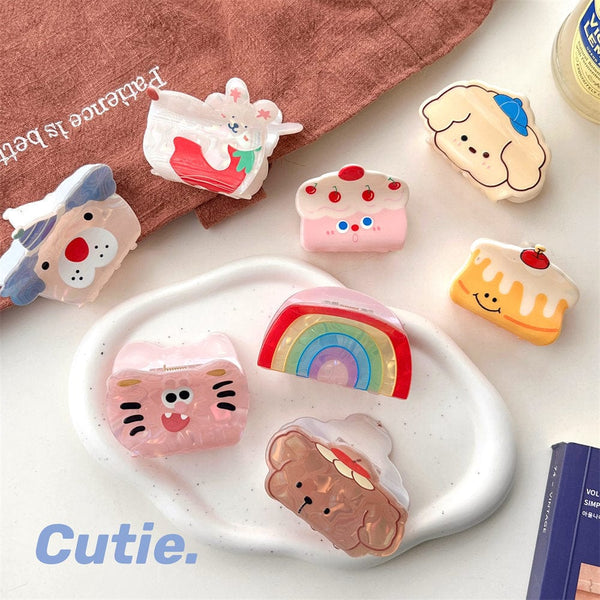 Cute cartoon-themed acrylic hair clips for women, featuring various playful designs like bunnies, kittens, and rainbows.
