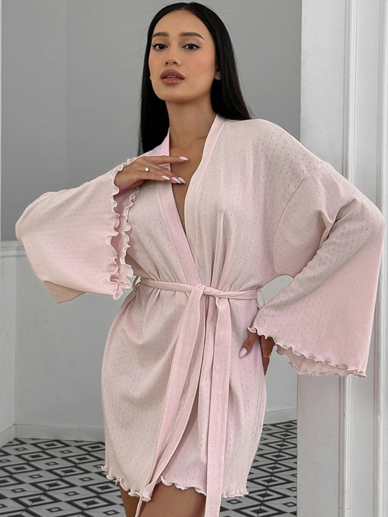 Light pink tie waist kimono sleeve lounge nightgown with ruffled edges on model