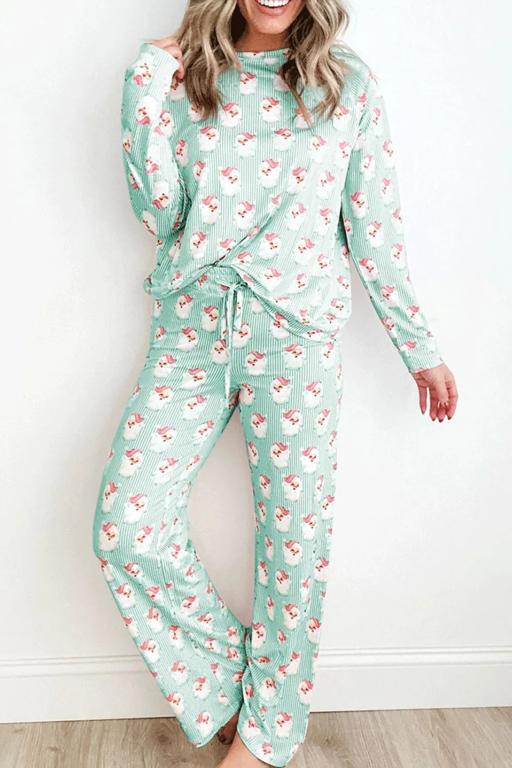 Woman wearing mint green Santa print long sleeve top and pants lounge set