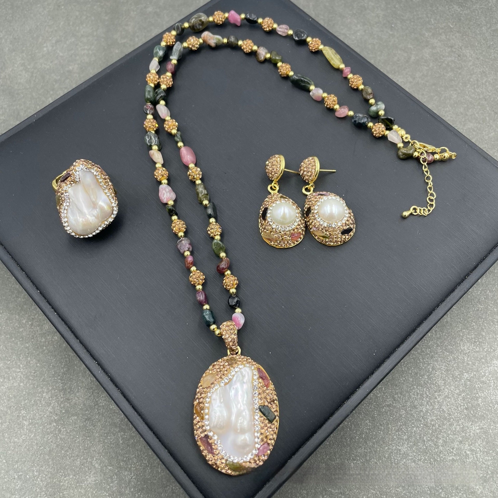 Natural freshwater pearl jewelry set with necklace, earrings, and ring on a tourmaline chain.