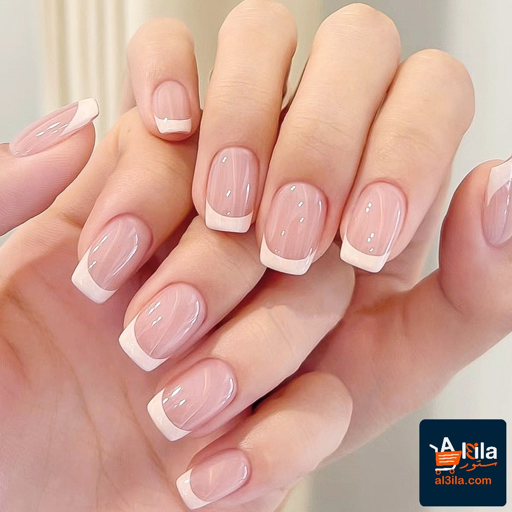 Square short fake nail tips with white French manicure design.