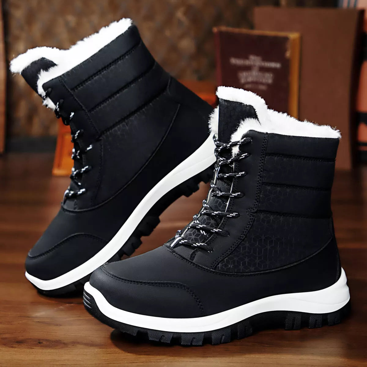 black winter waterproof snow boots with warm white fur lining and low heels on wooden floor