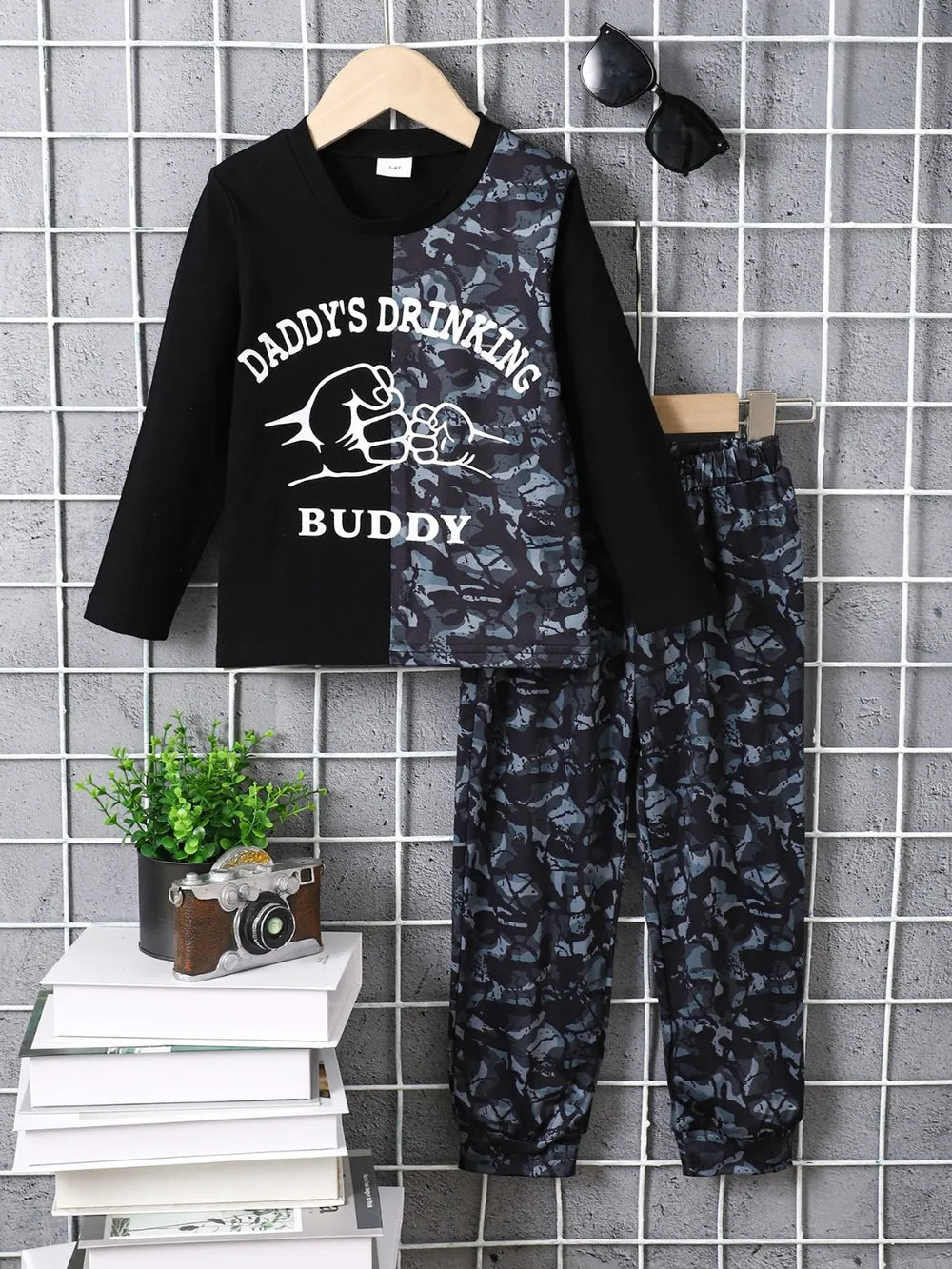 Children's camouflage color block top and pants set with black and camo design, long sleeves, and printed text "Daddy's Drinking Buddy"
