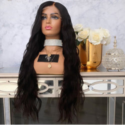 Women's black long curly wig with big waves on mannequin.