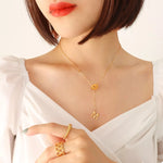 18K gold-plated titanium steel letter pendant necklace worn by woman with short hair and white top