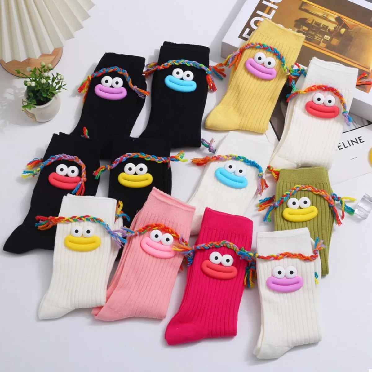 Colorful cartoon ribbed knit crew socks with playful face designs and braided details, one size cotton pair.