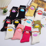 Colorful cartoon ribbed knit crew socks with playful face designs and braided details, one size cotton pair.
