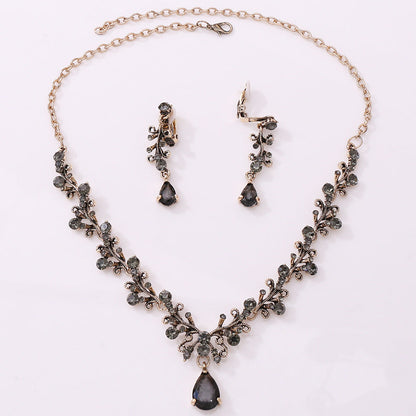 Bridal rhinestone zircon necklace and earring set with intricate design in antique gold.
