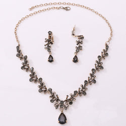 Bridal rhinestone zircon necklace and earring set with intricate design in antique gold.