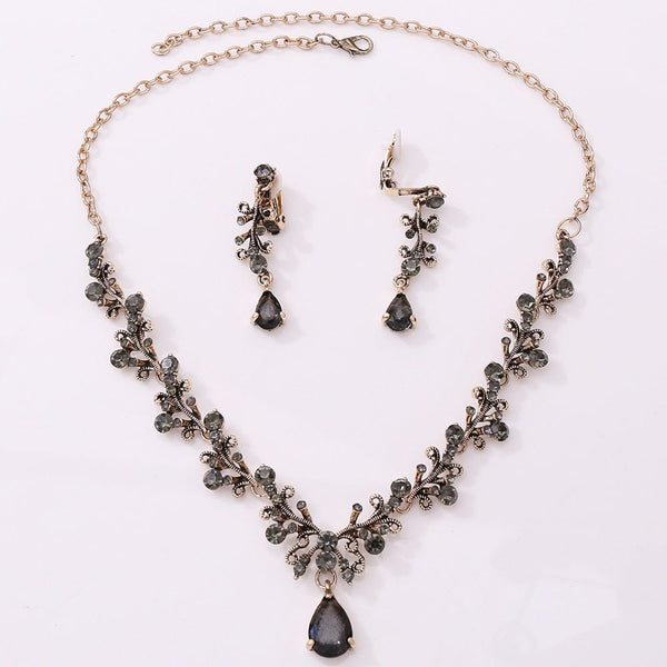 Bridal rhinestone zircon necklace and earring set with intricate design in antique gold.