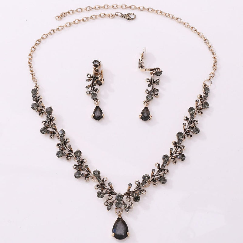 Bridal rhinestone zircon necklace and earring set with intricate design in antique gold.