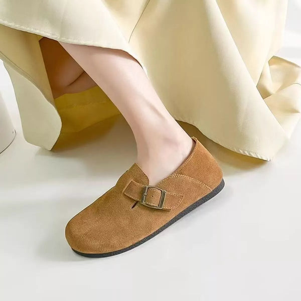 Brown round toe buckle slip-ons in PU leather with rubber soles worn with beige dress