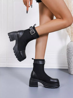Black round toe block heel boots with buckle strap and chunky rubber sole