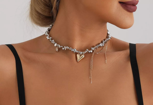 Close-up of a woman wearing a silver-plated heart necklace with an 18K gold-plated heart pendant and alloy chain with extension, styled with black straps.