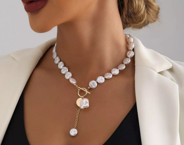 18K gold-plated pearl drop necklace with synthetic pearls on model wearing white blazer