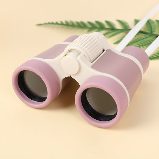 Children's outdoor eye protection binoculars in beige and pink design on a light background.