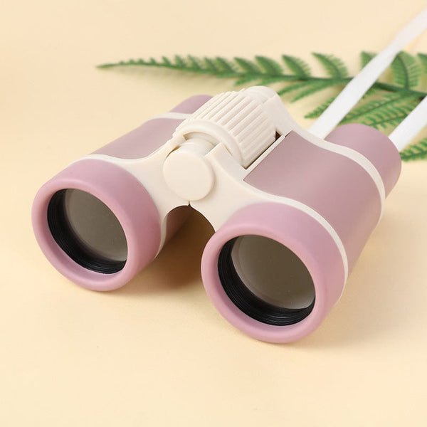 Children's outdoor eye protection binoculars in beige and pink design on a light background.