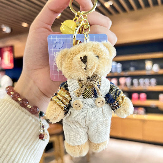 Cartoon key button plush bear doll with overalls as a schoolbag pendant.