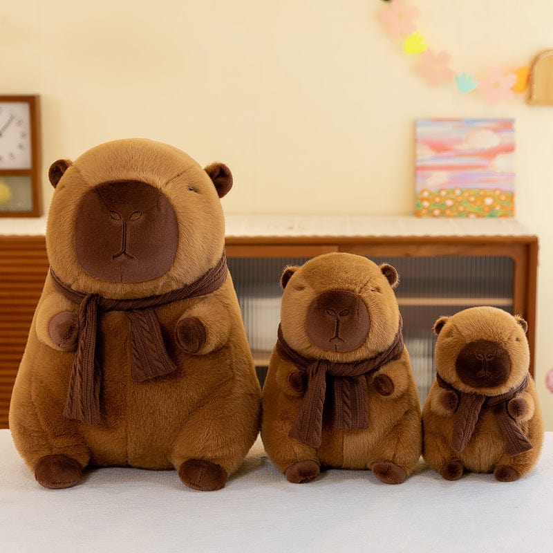 Cute Scarf Capibala figurine dolls in various sizes displayed on a table.