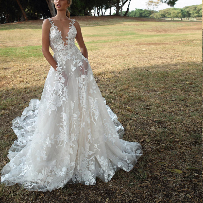 Elegant white lace wedding dress with sexy suspenders and floral design.