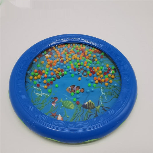 Colorful wave drum with sea life design, features blue frame and multicolored beads, ideal for children aged 4-6 as a portable percussion instrument.