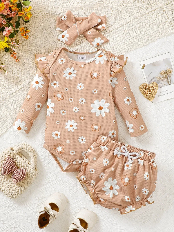 Children's ruffled floral bodysuit with matching bloomers and headband set in peach color with white and orange flowers
