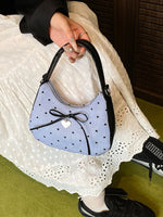 Small printed bow shoulder bag in blue with black polka dots, PU leather handle, and heart charm detail