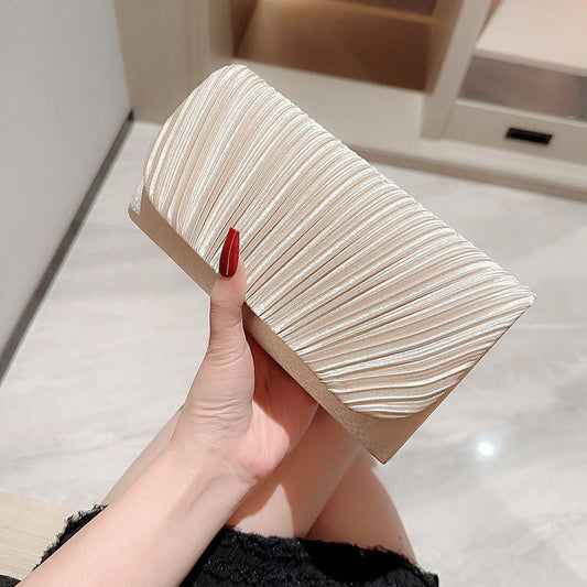 Fashionable women's casual bag with folding design in champagne color.