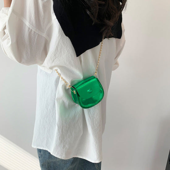 Women's messenger bag in green PU with chain strap, shell shape design.
