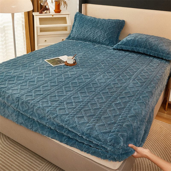 Winter thermal flannel coral fleece fitted sheet on bed with pillows, showcasing fleece-lined non-slip material.