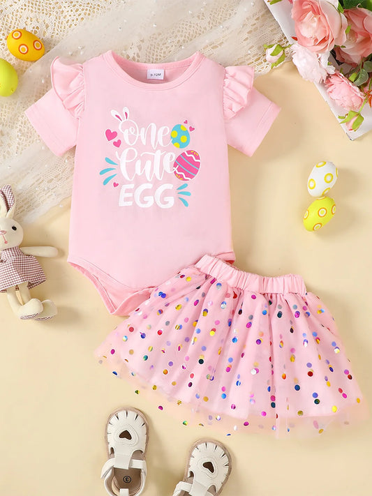 Pink children's ruffled graphic bodysuit with "One Cute Egg" text and polka dot mesh skirt set with colorful sequins